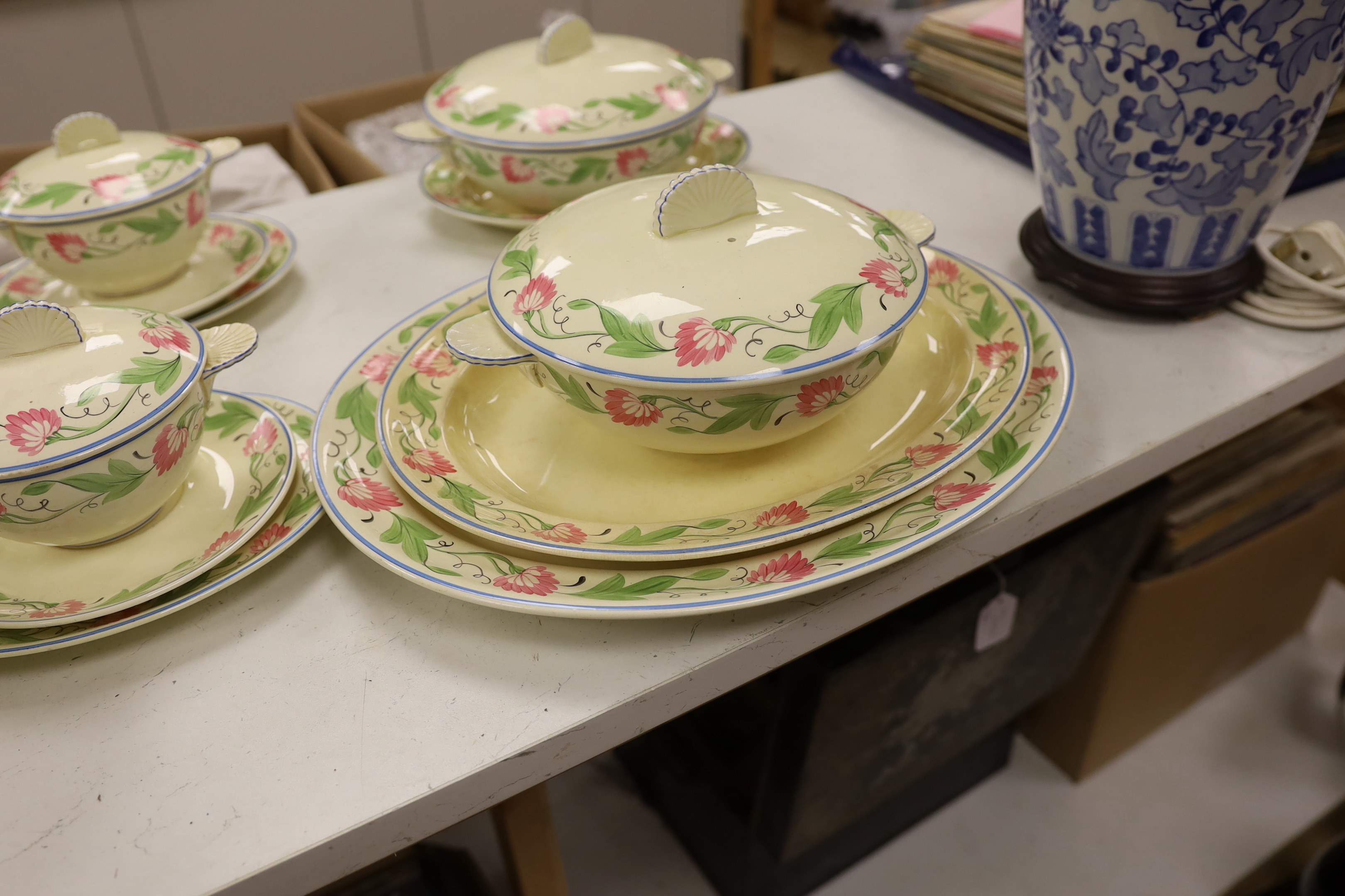 A Wedgwood floral pattern dinner service, c.1934 including twin handled cups, dinner plates and serving dishes, largest 42cm wide